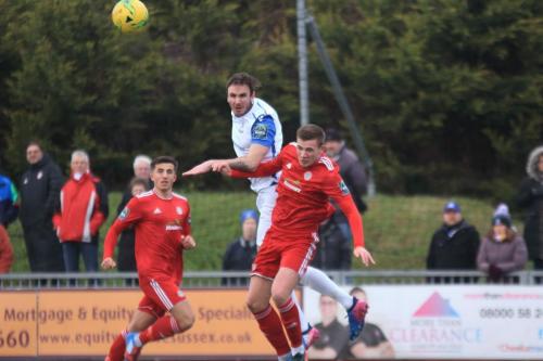 Enfields Matt Johnson (centre) wins a header against Joel Colbran