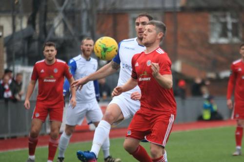 Enfields Matt Johnson (whirte, R) challenges Darren Budd