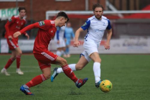 Worthings Billy Barker (L) clears from Remi Sutton