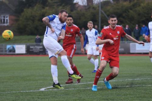 Worthings James Crane (R) blocks Billy Bricknells shot