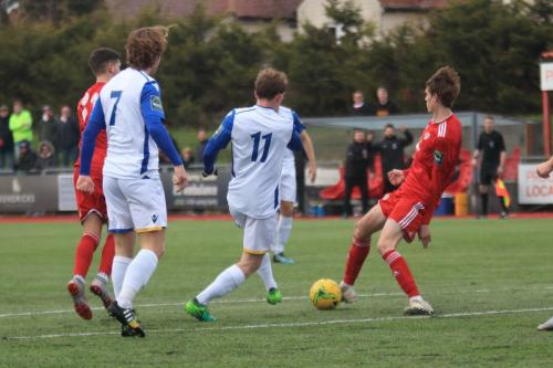 Worthings Joe Clarke (R) clears from Aaron Greene