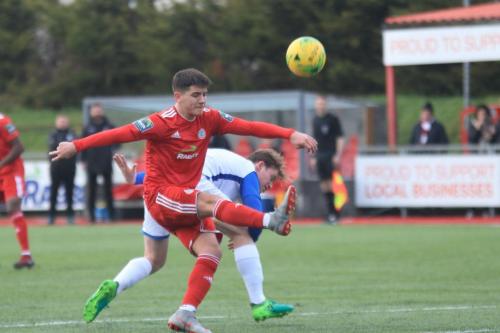 Worthings Ricky Aguiar (red) challenges Aaron Greene