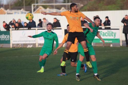 Cheshunts Tanasheh Abrahams (amber) challenges Lyle Della-Verde