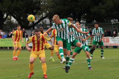 Chichester captain Connor Cody heads clear