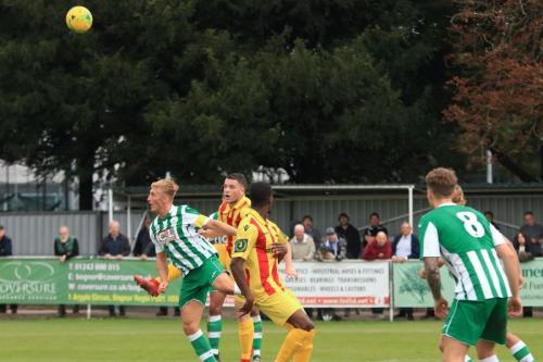 Chichesters Connor Coady (L) heads clear from Alex Read