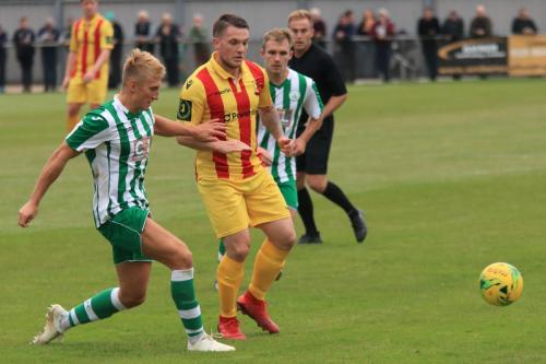 Chichesters Connor Cody (L) clears from Alex Read