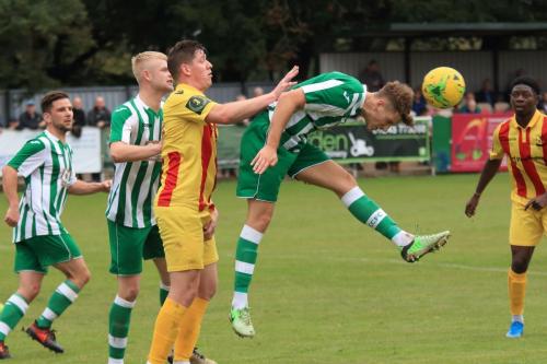 Chichesters Jamie Horncastle heads clear from Glenn Wilson