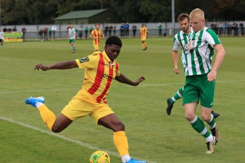 Enfields Charles Brown crosses as Corey Heath tries to blockx