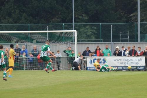 Enfields Joe Payne clears for a corner after Nathan McDonalds save from Josh Clacks (7) free kick  Clack appears to be celebrating prematurely