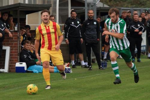 Enfields Lewis Taaffe (L) pulls up with a hamstring injury forcing an early substitution