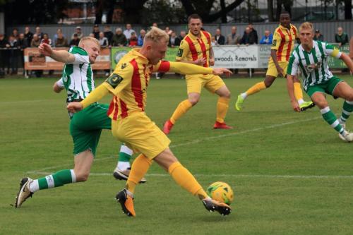 Enfields Ryan Blackman crosses under pressure from Corey Heath