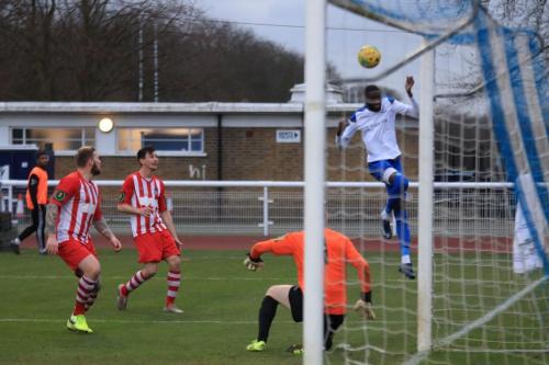 After his initial shot has been saved by Callum Chafer, Enfields Muhammadu Fall heads the ball back into the danger area