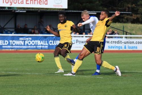 Enfields Ryan Blackman shoots under pressure from Ben Acquaye (L) and Nathan Hicks