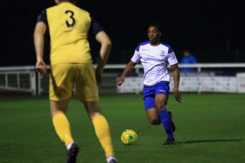 Enfields Jonm Muleba (R) runs at ex-Enfield man Remi Sutton