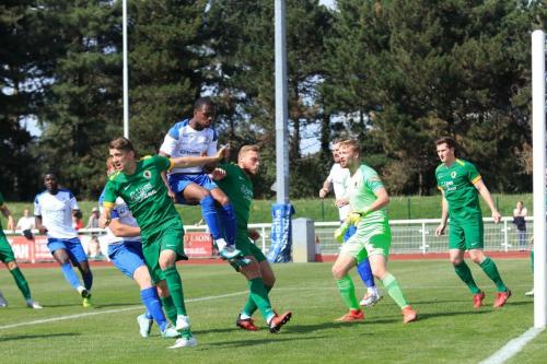 Enfields Ken Charles (white shirt) challenges Steve Metcalf (L) and Will Miles