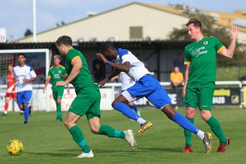 Enfields Muhammadu Faal runs at Charlie Harris and Ben Dyett (L)