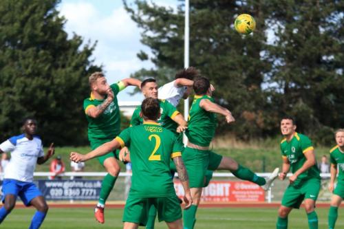 Enfields Sam Youngs (white) gets his head to the ball despite the  attentions of three defenders