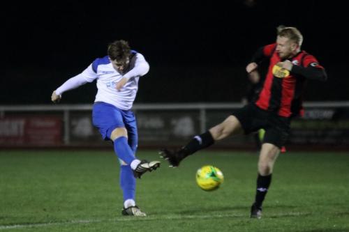 Enfields Lewis Taaffe shoots as James Hammond tries to block
