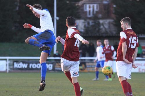 Bognors Josh Flint (centre) clears from Sam Youngs as Ashton Leigh looks on