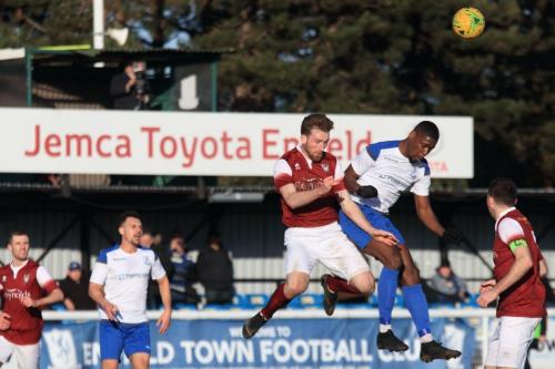 Bognors Keaton Wood (L) challenges Shaun Okojie