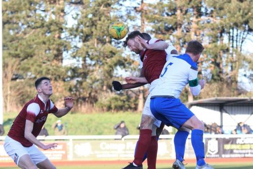 Bognors Keaton Wood (maroon, R) heads clear from Marc Weatherstone (5) and Shaun Okojie