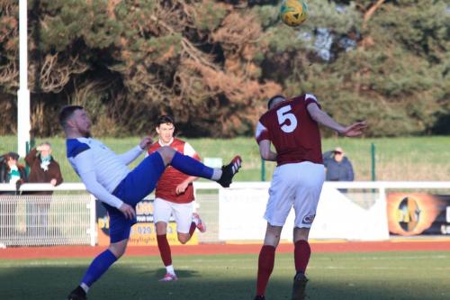 Bognors Matt Casey (5) heads clear from Billy Bricknell