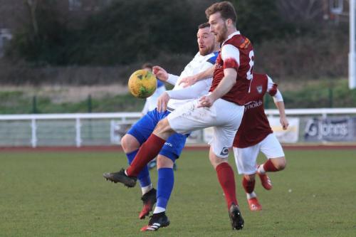 Enfields Billy Bricknell (white) flicks tha ball past Keaton Wood
