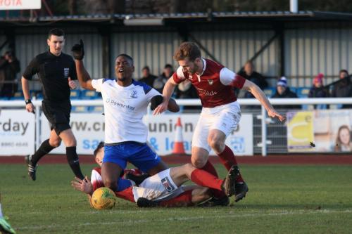 Enfields Shaun Okojie is brought down on the edge of the area