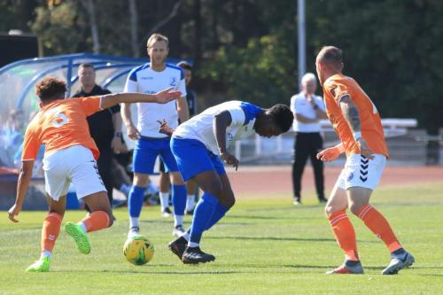 Braintrees Cameron Green (L) and Adam Mills and Enfields Charles Brown