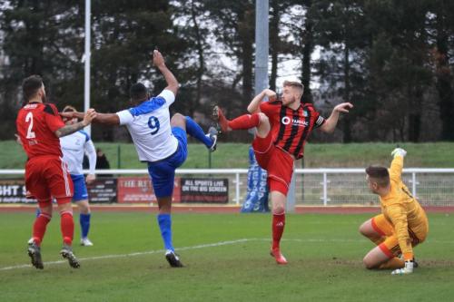 Enfields Kezie Ibe (9) and Regents Matt Cripps challenge for the loose ball after a save by Charlie Turner