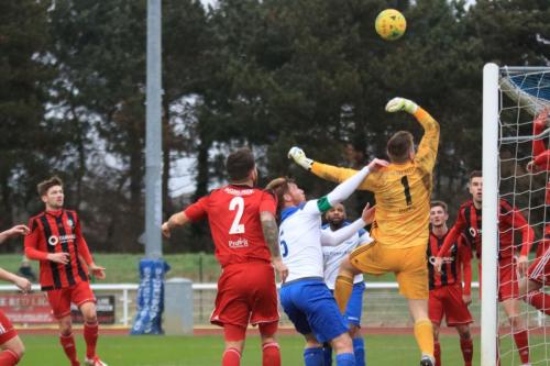 Regent keeper Charlie Turner is almost beaten by an inswinging corner but just manages to turn the ball to safety