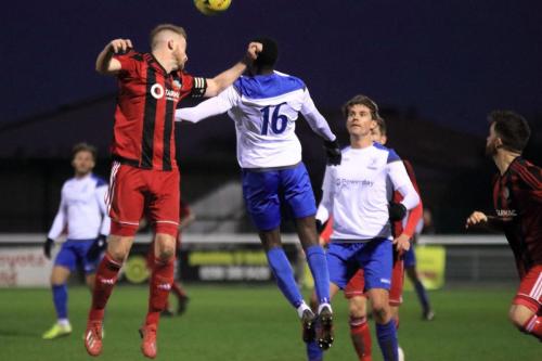 Regents Matt Cripps (L) heads clear from Bobson Bawling