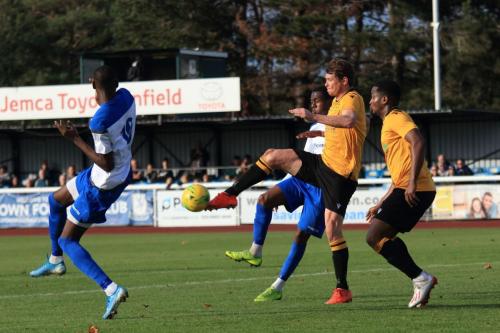 Cheshunts Sean Cronin clears from Ken Charles and Muhammadu Faal (L)