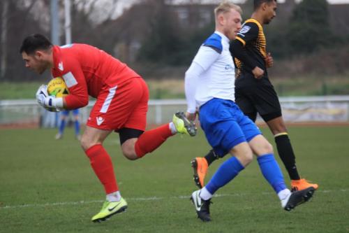Cray keeper Lewis Carey reaches the ball ahead of Ryan Blackman