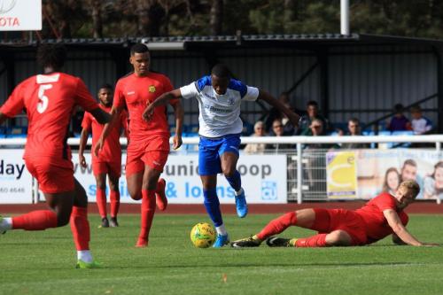 Enfields Ken Charles tackled by James Richmond (R)