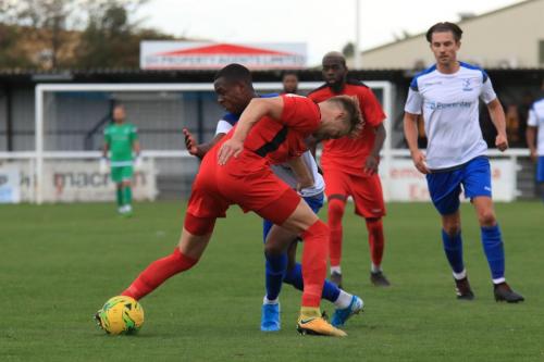 Enfields Ken Charles tries to get past James Richmond (red)