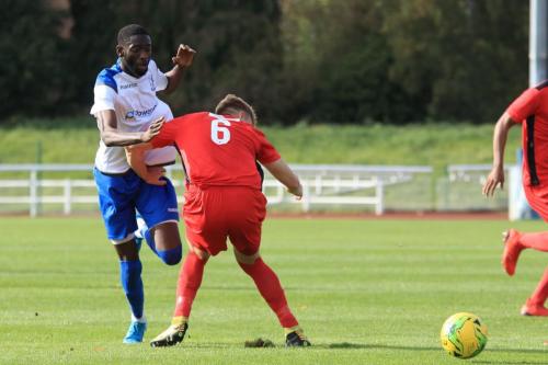Enfields Muhammadu Faal (L) knocks the ball past James Richmond