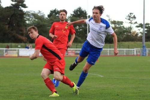 Enfields Sam Youngs and Mersthams Eddie Dines (L) and Bradley Wilson