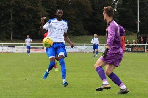 Merstham keeper Matte Pierson clears from Muhammadu Faal