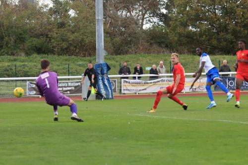 Merstham keeper Matte Pierson saves from Muhammadu Faal