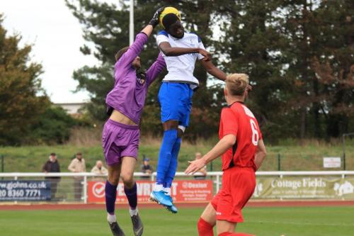Merstham keeper Matte Pierson saves from Muhammadu Faalx