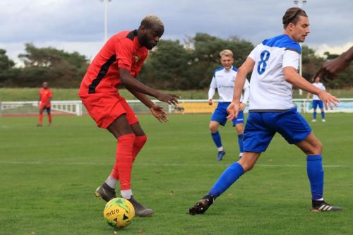 Mersthams Yannick Monga (L) and Enfields Sam Youngs