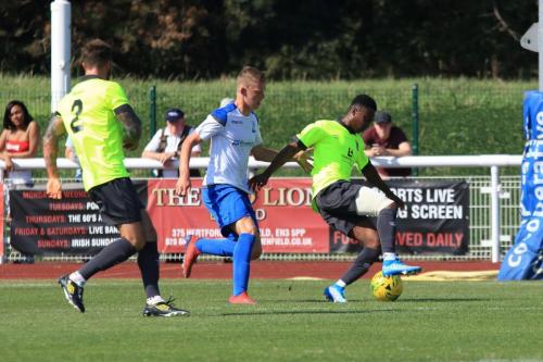 Enfields Joe Payne (centre) challenges Ryan Young