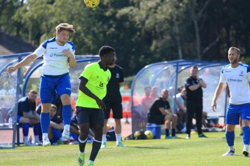 Enfields Lewis Taaffe (L) wins a header against Thomas Gogo