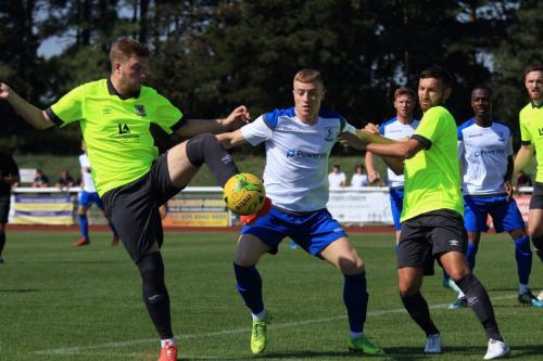 Enfields Sam Bantick challenges Keegan Cole (L) and Andy Lomas