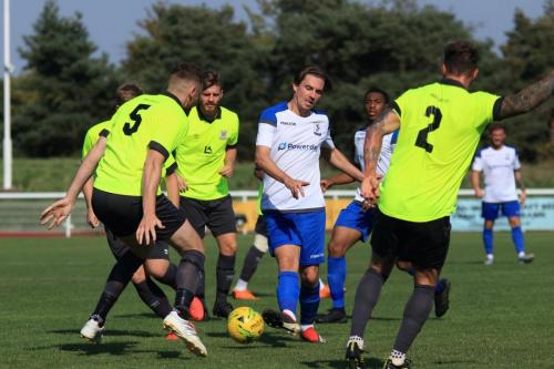 Enfields Sam Youngs (white) flicks the ball through a crowd of defenders