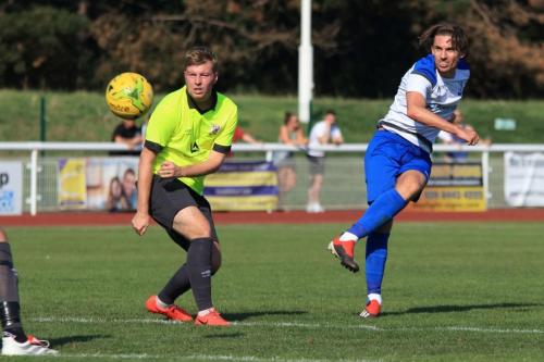 Enfields Sam Youngs and Potters Bars Keegan Cole watch the flight of Youngs shot