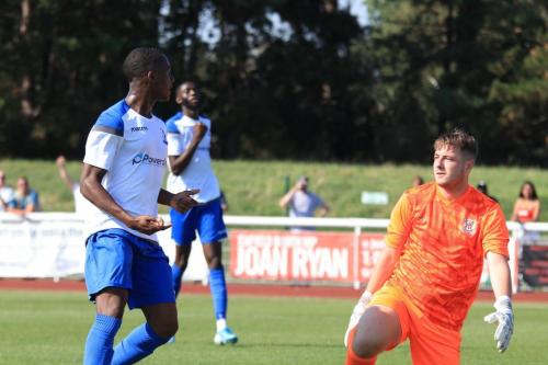 Ken Charles celebrates after beating Matt Nolan (R) for the first Enfield goal