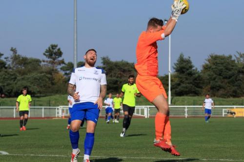 Potters Bar keeper Matt Nolan beats Billy Bricknell to a cross