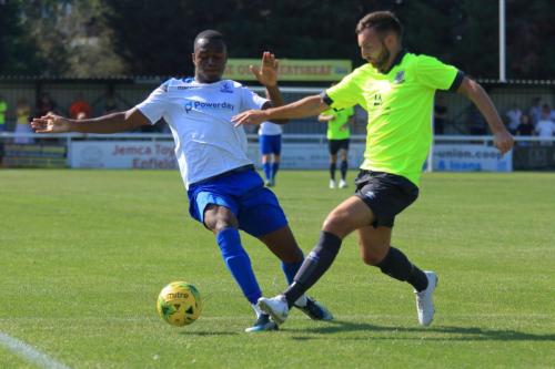 Potters Bars Andy Lomas (R) tackles Ken Charles